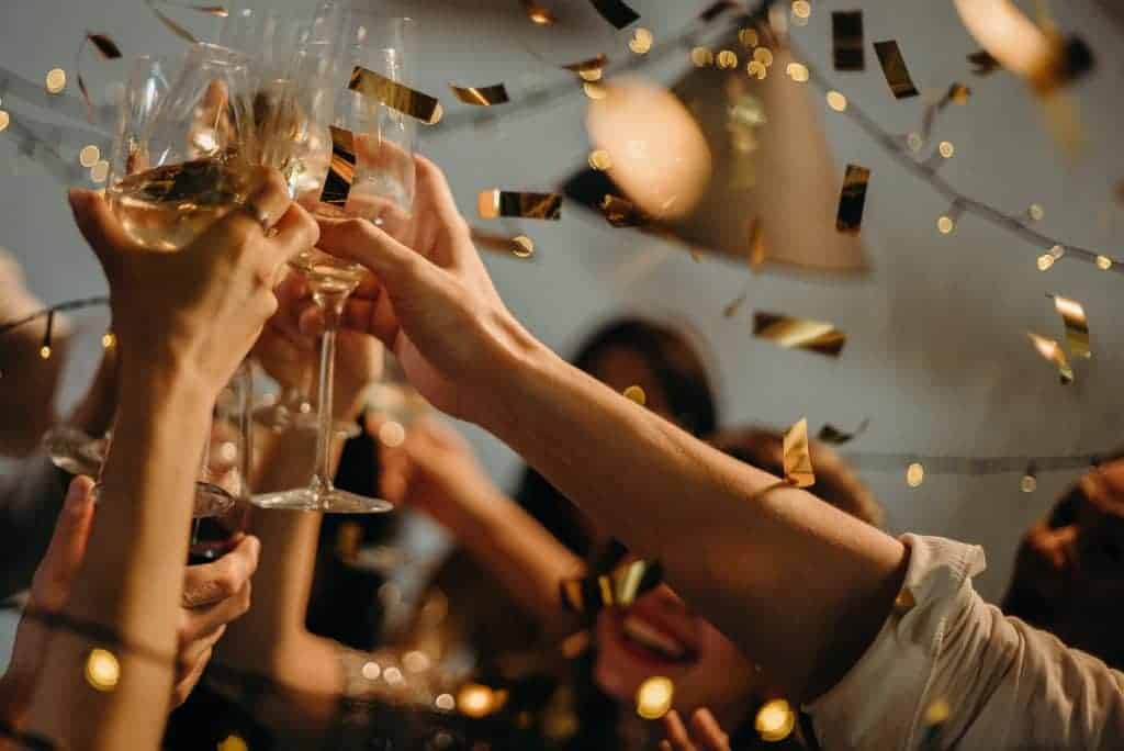 People toasting champagne flutes at party