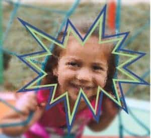 A young girl is playing on a jungle gym net. She is very blurry appearing and there are blue and green zigzag shapes around her face.