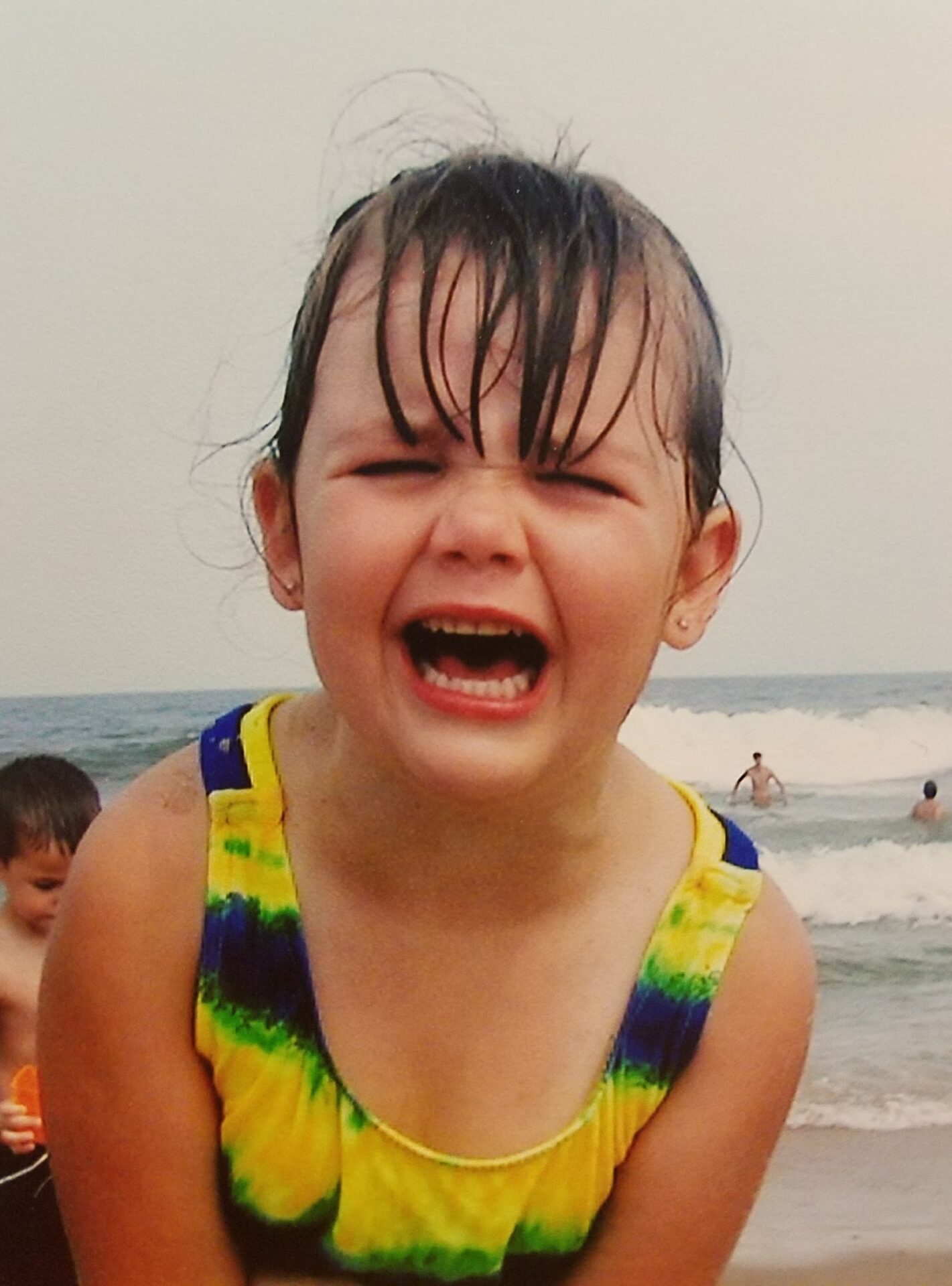 Young girl crying at the beach