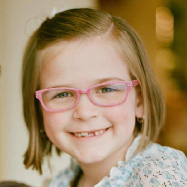 Young girl wearing pink glasses