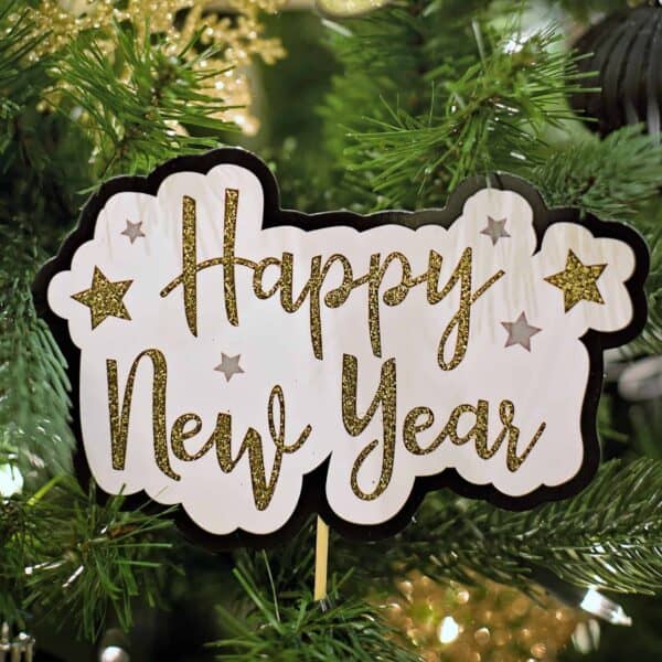Happy New Year in gold font in green pine tree